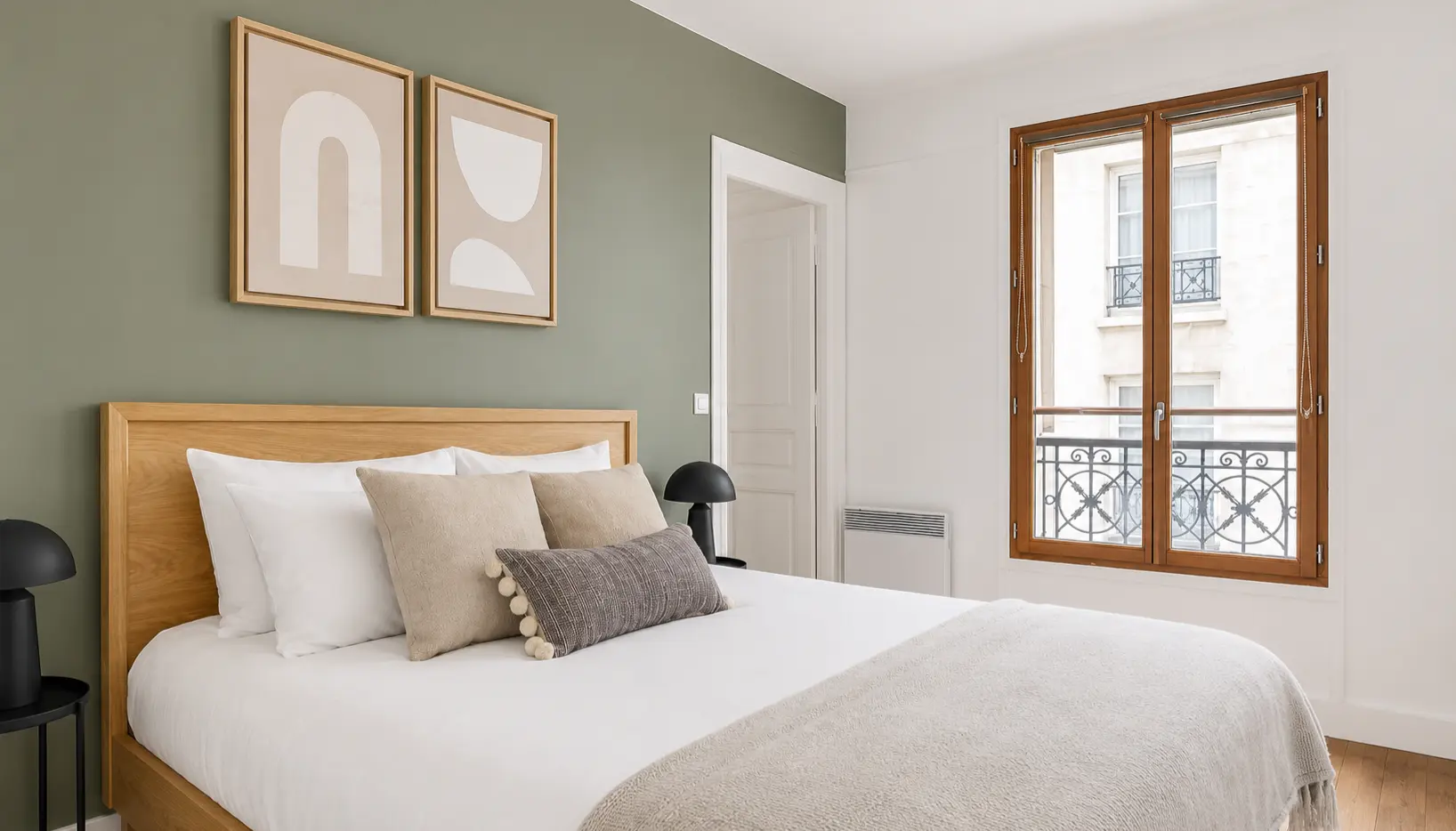 First bedroom with double bed, sage-green wall and French windows — Le Marais · Paris 4th, Paris, France