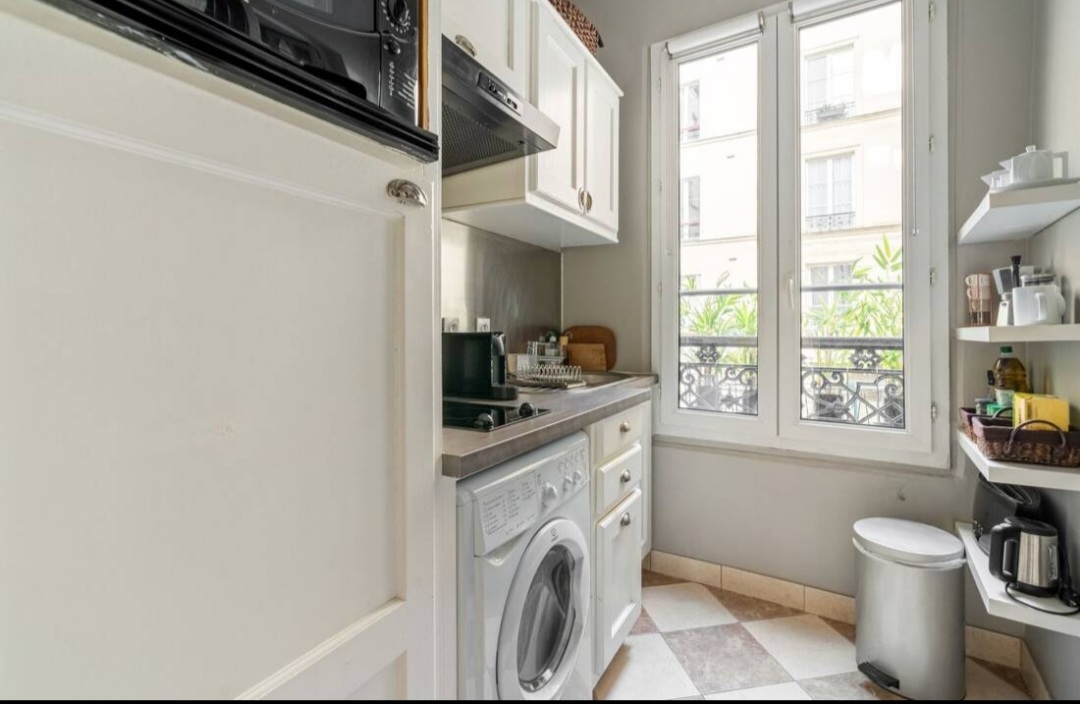 Bright kitchen with window over a quiet Paris 7th street and full appliances — Rue du Bac · Paris 7e