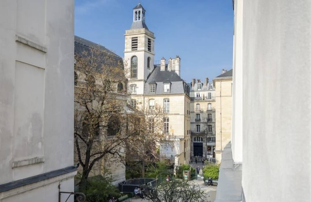 View from the apartment towards a Le Marais church tower and Haussmann façades