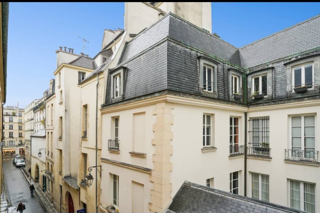 Rooftops and quiet street of the 4th arrondissement seen from the apartment