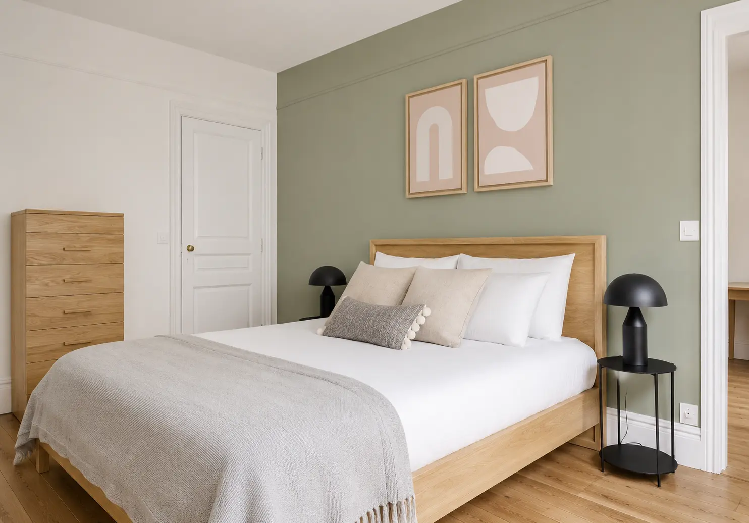 First bedroom with wooden bed frame, wardrobe and bedside lamps — Le Marais · Paris 4th, Paris, France