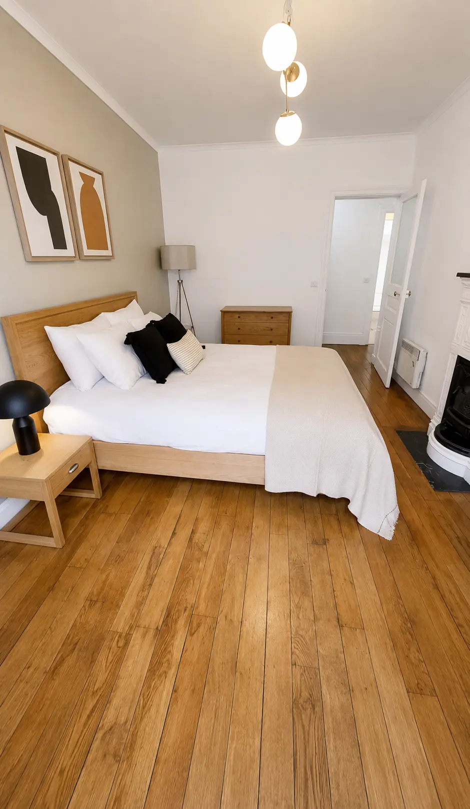Second bedroom with double bed, fireplace and pendant lighting — Le Marais · Paris 4th, Paris, France