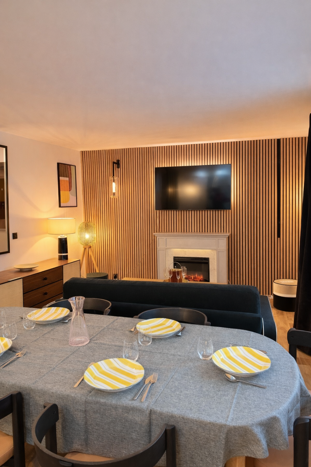 Dining area set for six, opening onto the living room and fireplace — Paris 16th · Auteuil, Paris, France