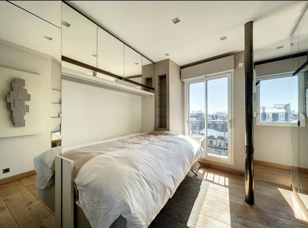 Second bedroom with mirrored joinery and rooftop views
