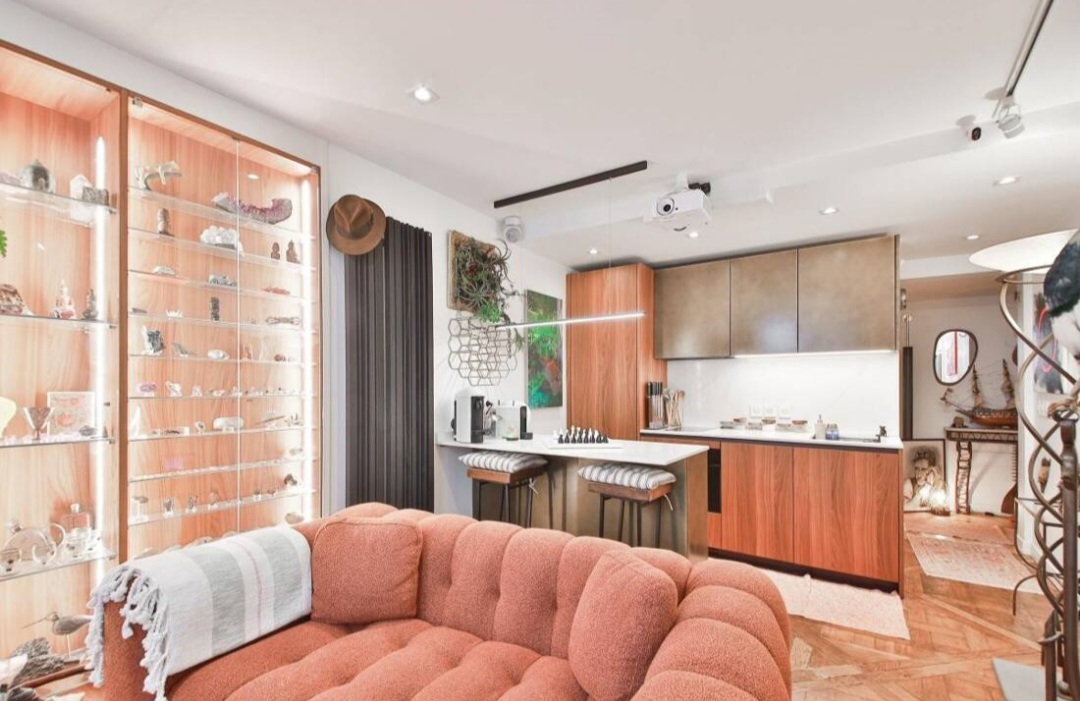 Living space with illuminated display cabinet and parquet flooring