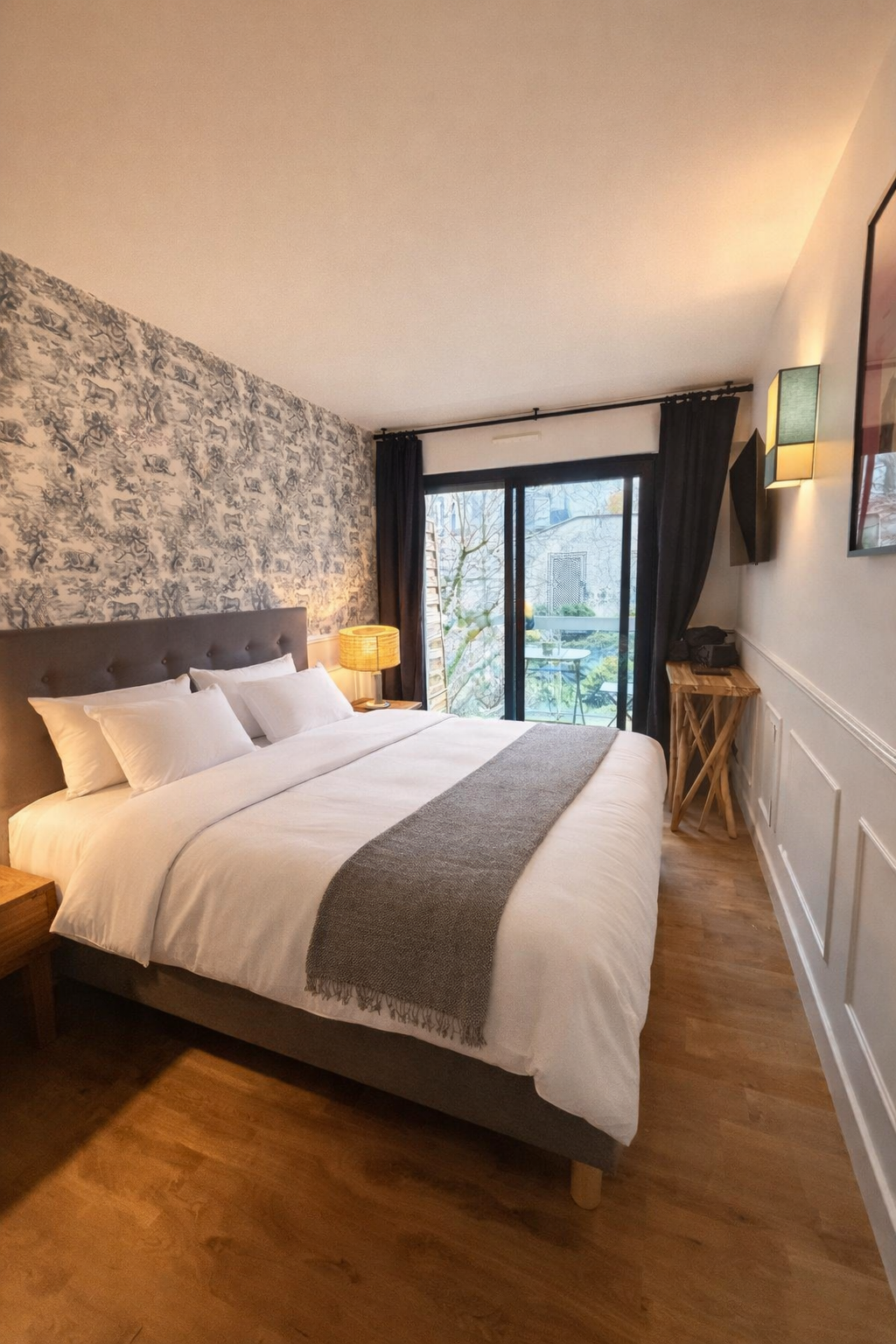 Bedroom with double bed, hotel linen and glazed doors to a small balcony — Paris 16th · Auteuil, Paris, France