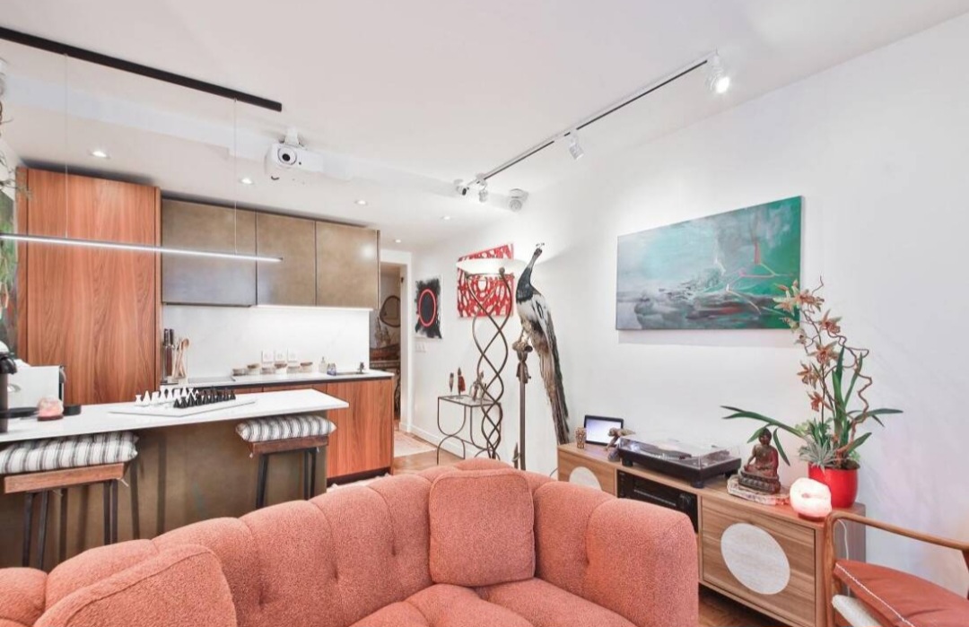 Open-plan living and dining area with breakfast bar and designer lighting