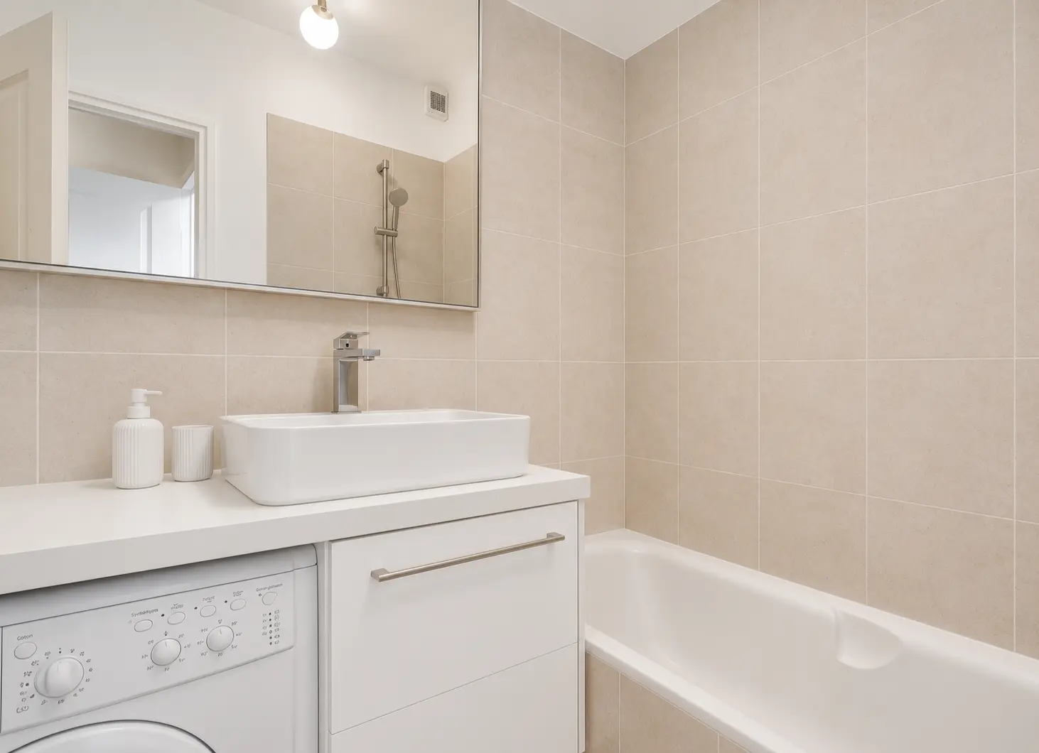 Modern bathroom with bathtub, vanity and washing machine — Le Marais · Paris 4th, Paris, France