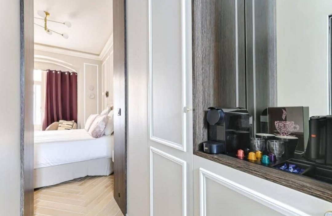 Coffee machine nook and wardrobes opening onto the sleeping area