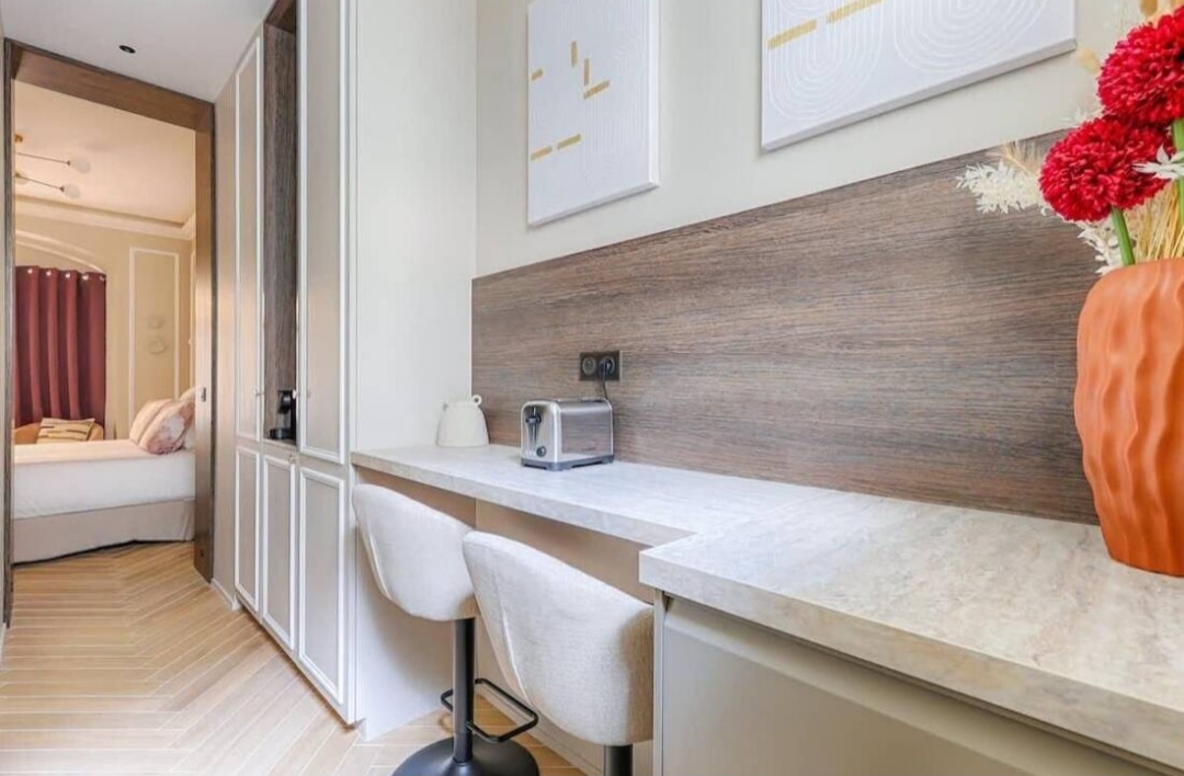 Dining and work counter with bar stools beside built-in storage