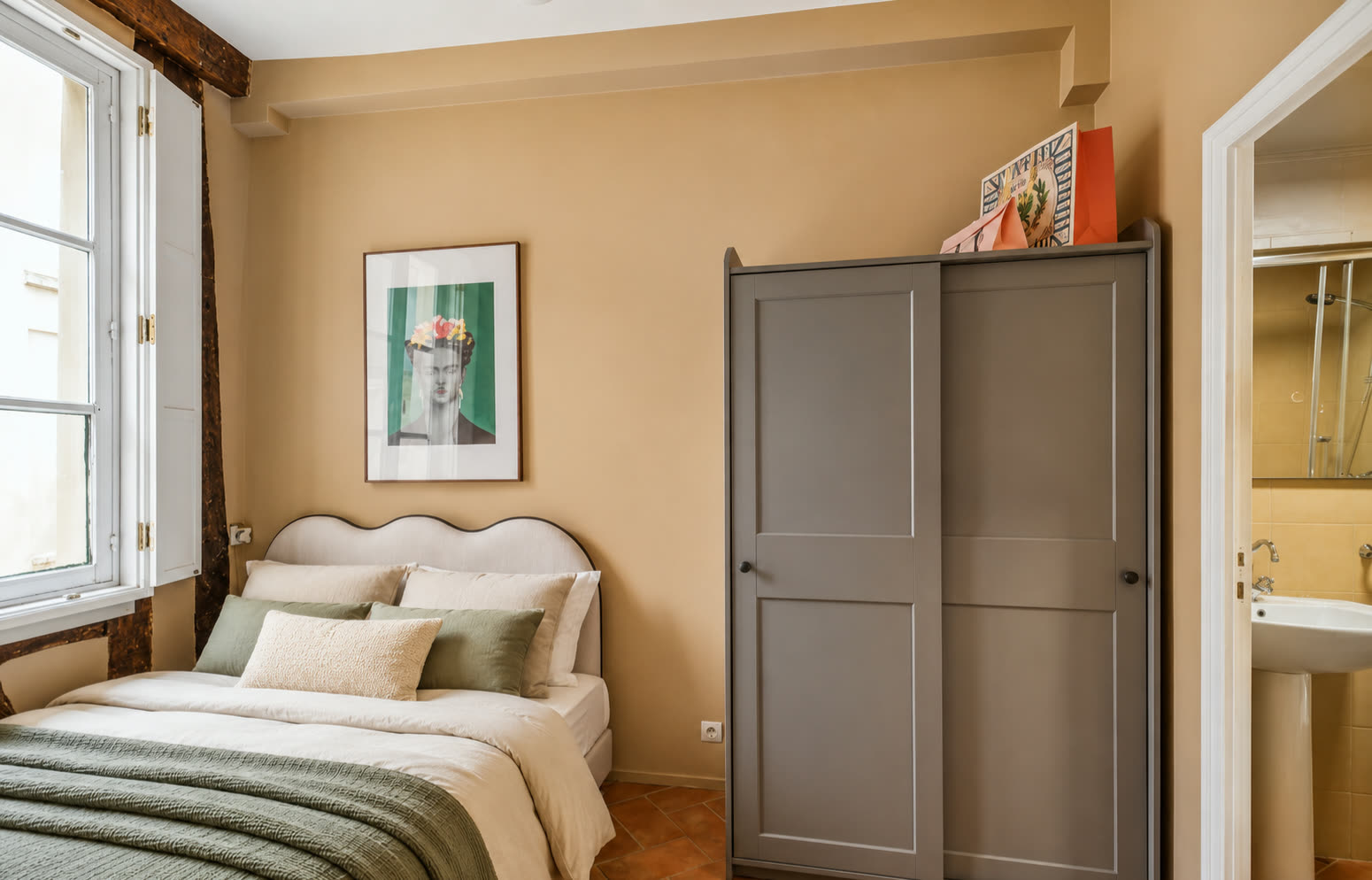 Separate bedroom in Le Marais apartment with double bed, wardrobe and bathroom access